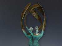 Exultation  Two figures come together forming one base and winding forever upwards towards the sun.  Pit fired ceramic and Apoxie. 32 x 7 x 11   $1600.00