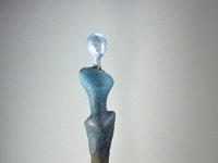 Roots  From a base of sandstoneand a found root emerges a simple calm figure in contrast to the complicated growth which forms its origins. 42 x 24 x 5 inches   $2850.00